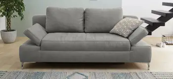 Graues 2-Sitzer Sofa mit verstellbaren Armlehnen und strukturierter Stoffoberfläche, moderne Einrichtung mit Pflanzen und Treppe im Hintergrund.